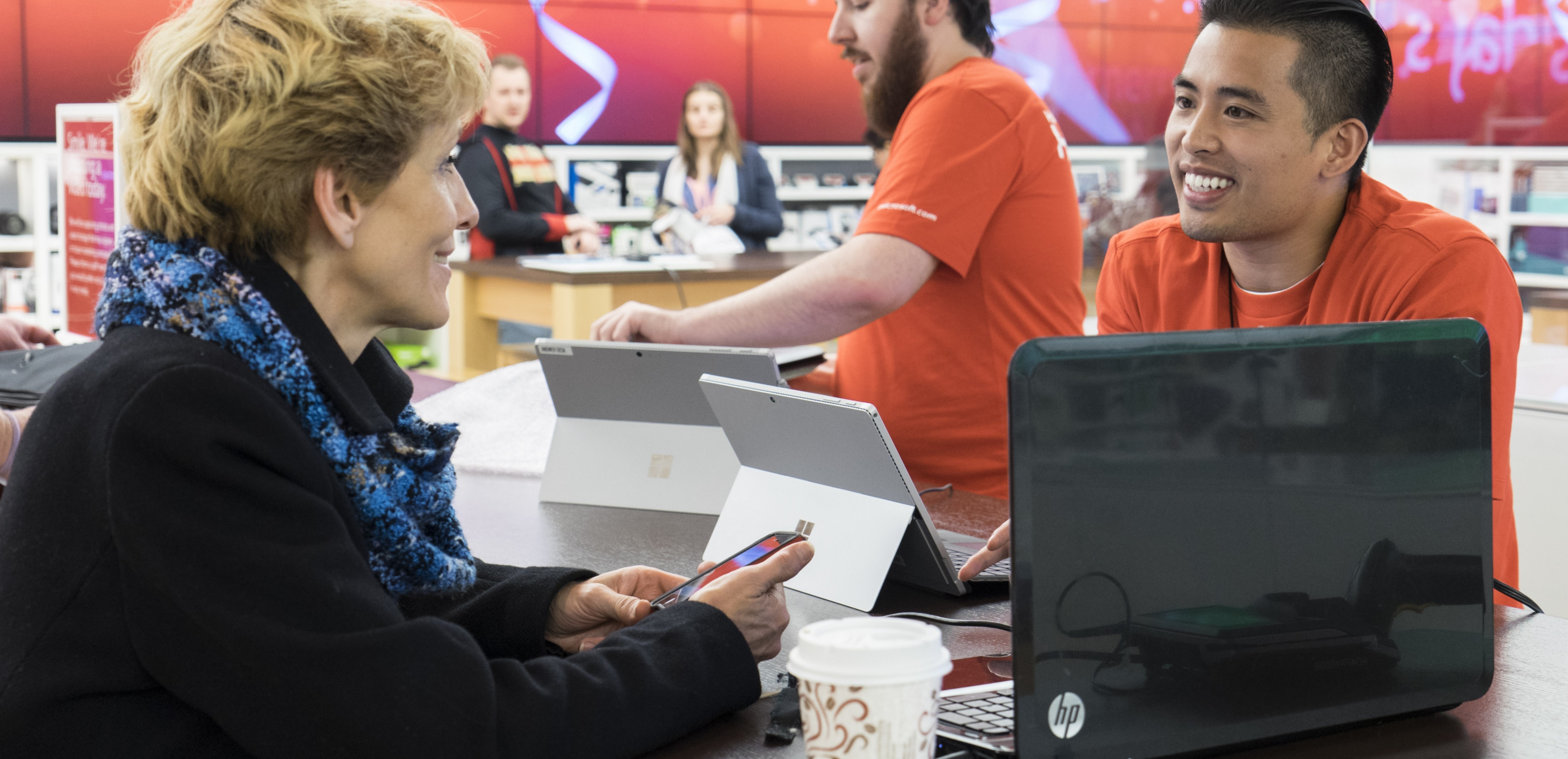 Man assisting woman in the Microsoft Store