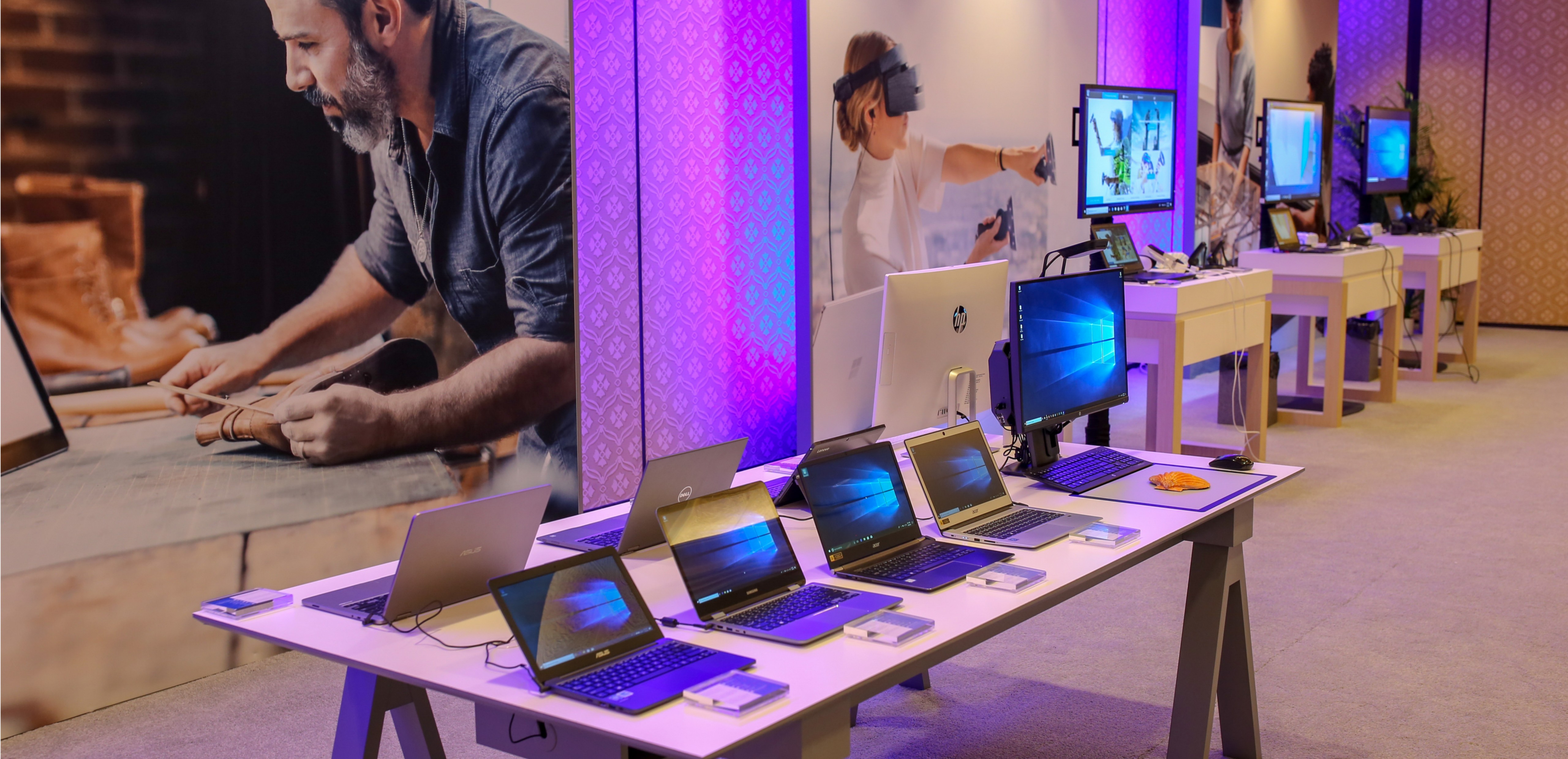 Image of Microsoft Experience Center at CES with different OEM PCs displayed on a table.