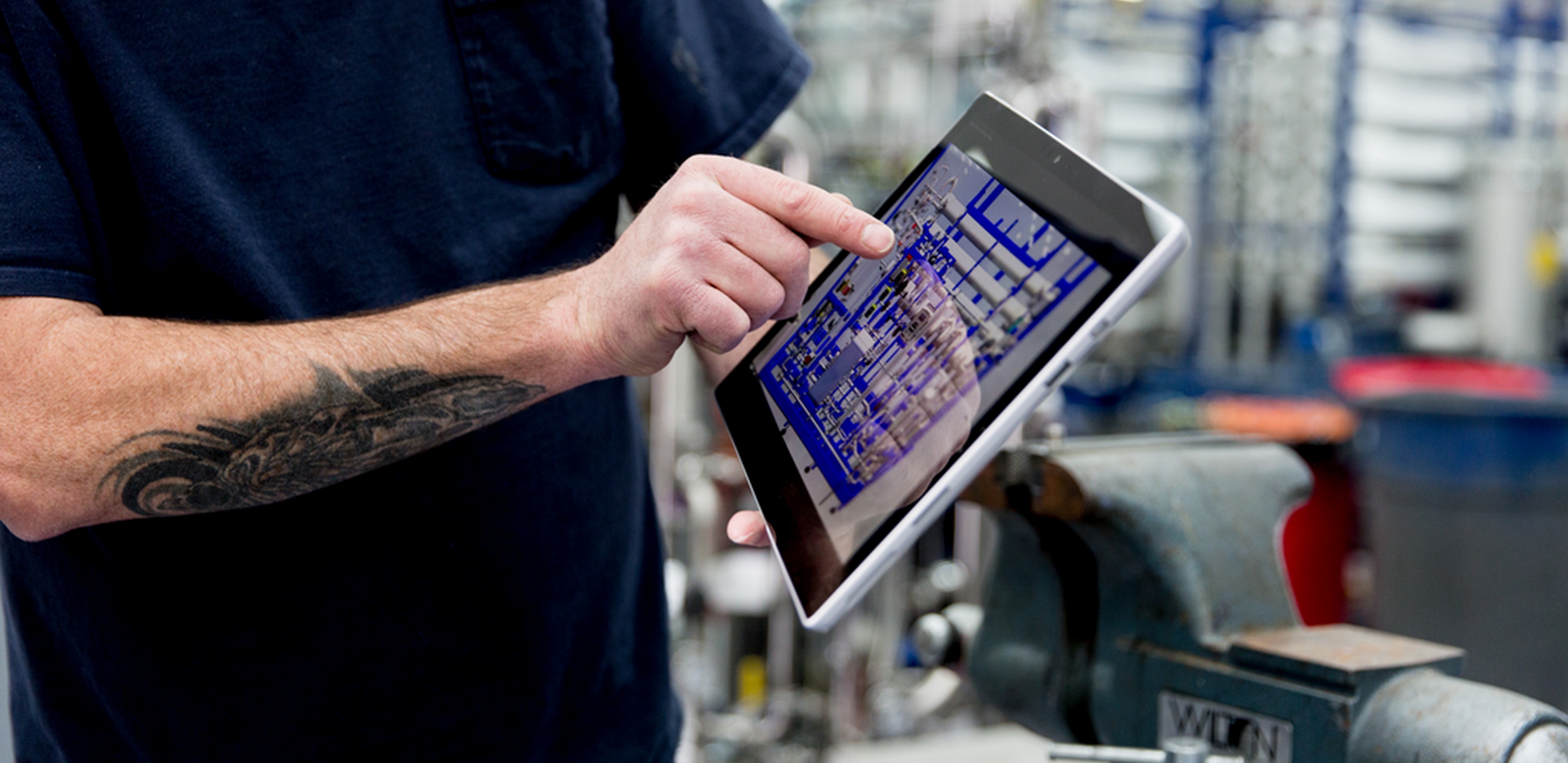 Person's hand shown holding a Surface Pro.