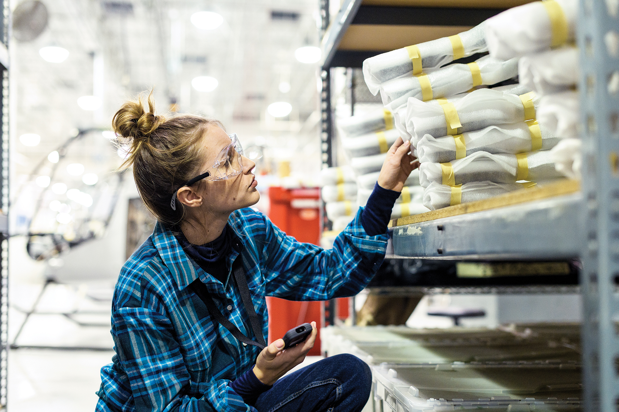 Woman wearing glasses in a factory