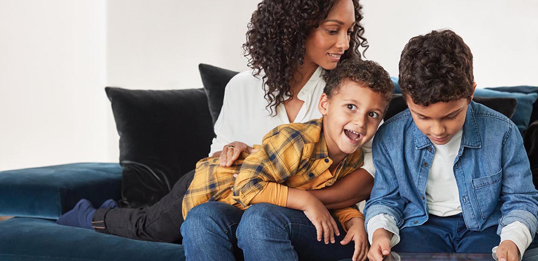 Mother on a couch with her two boys