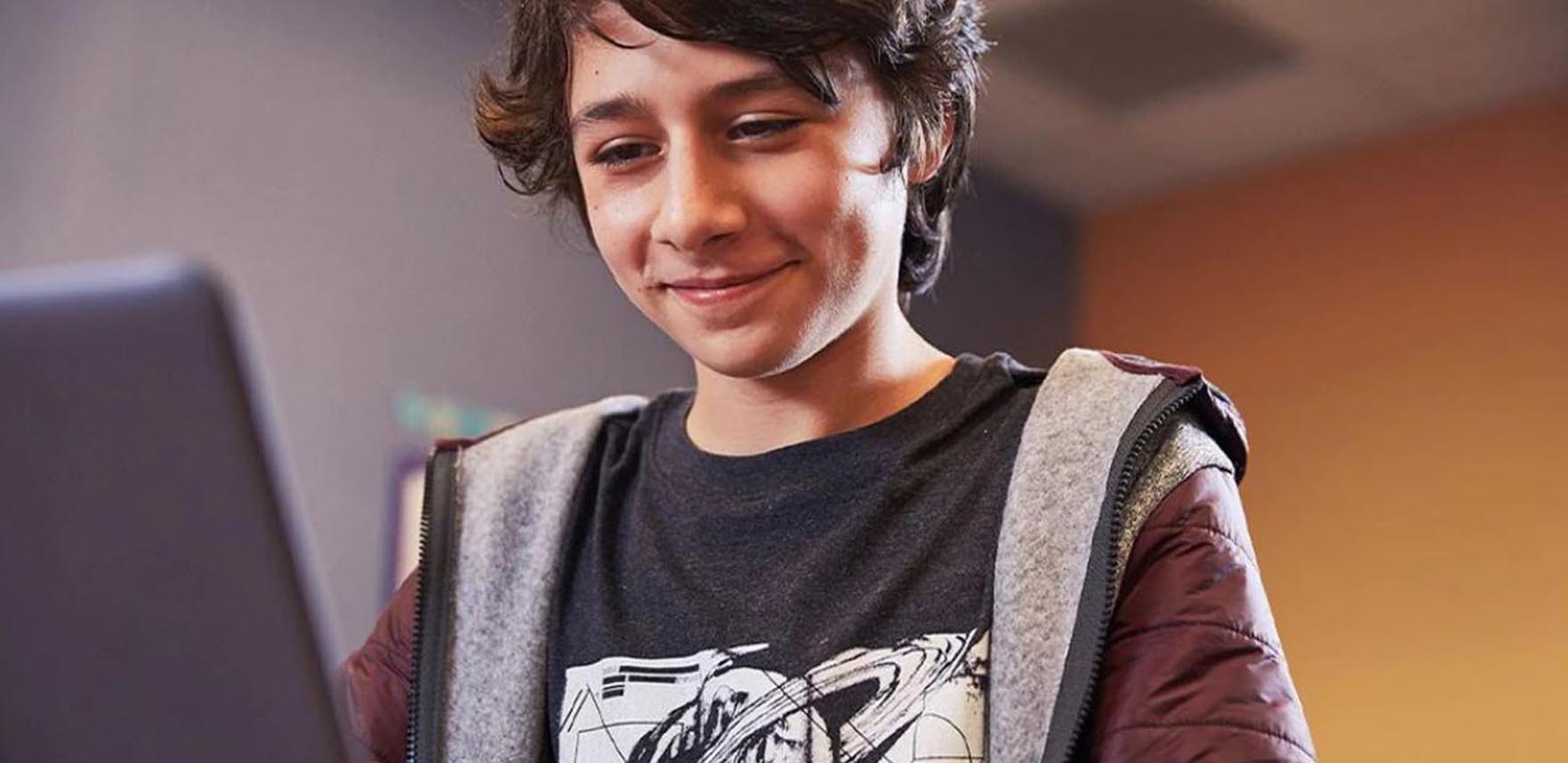 Teenage boy using a laptop computer