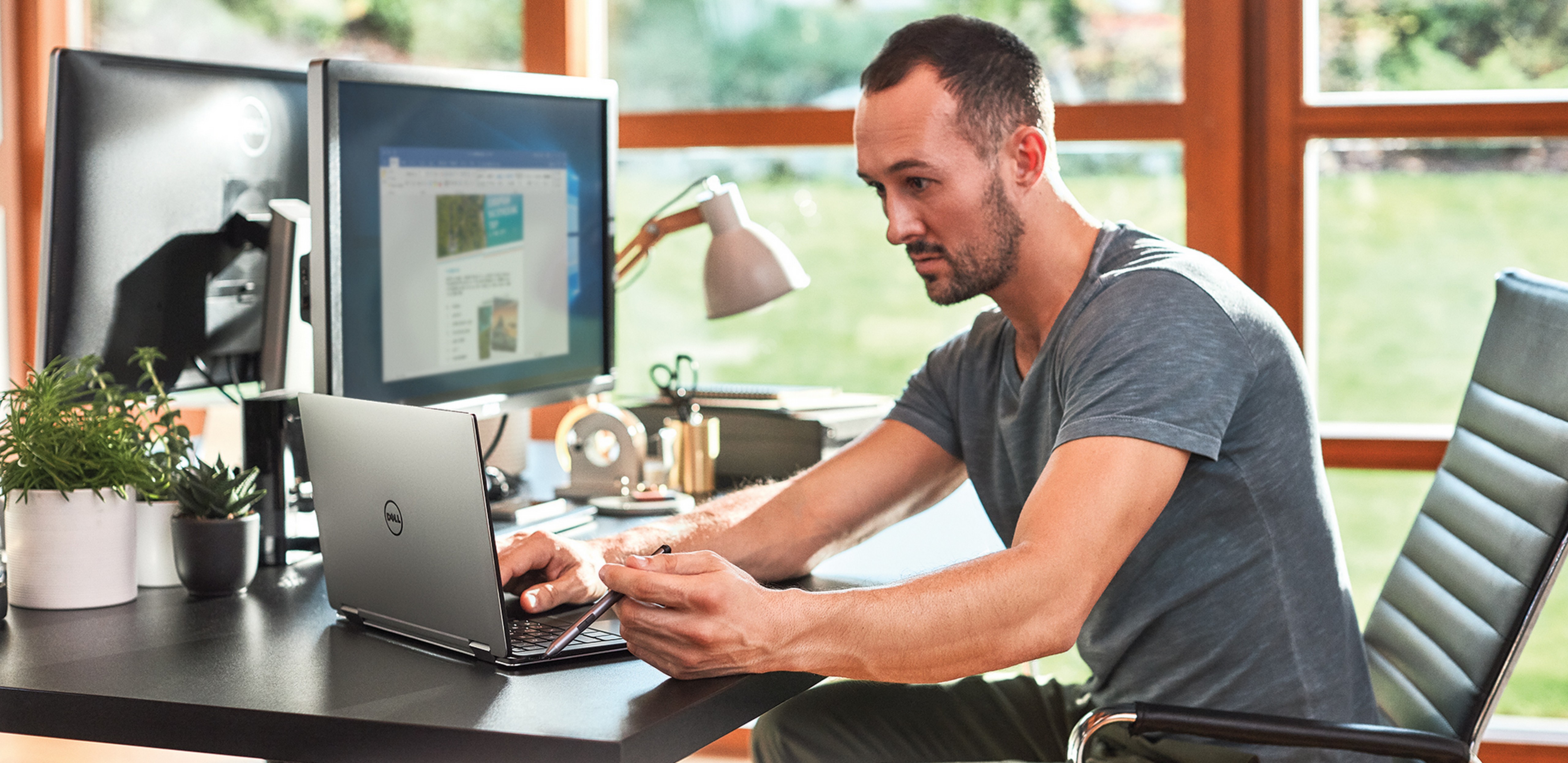 Man sitting at desk working on a laptop.