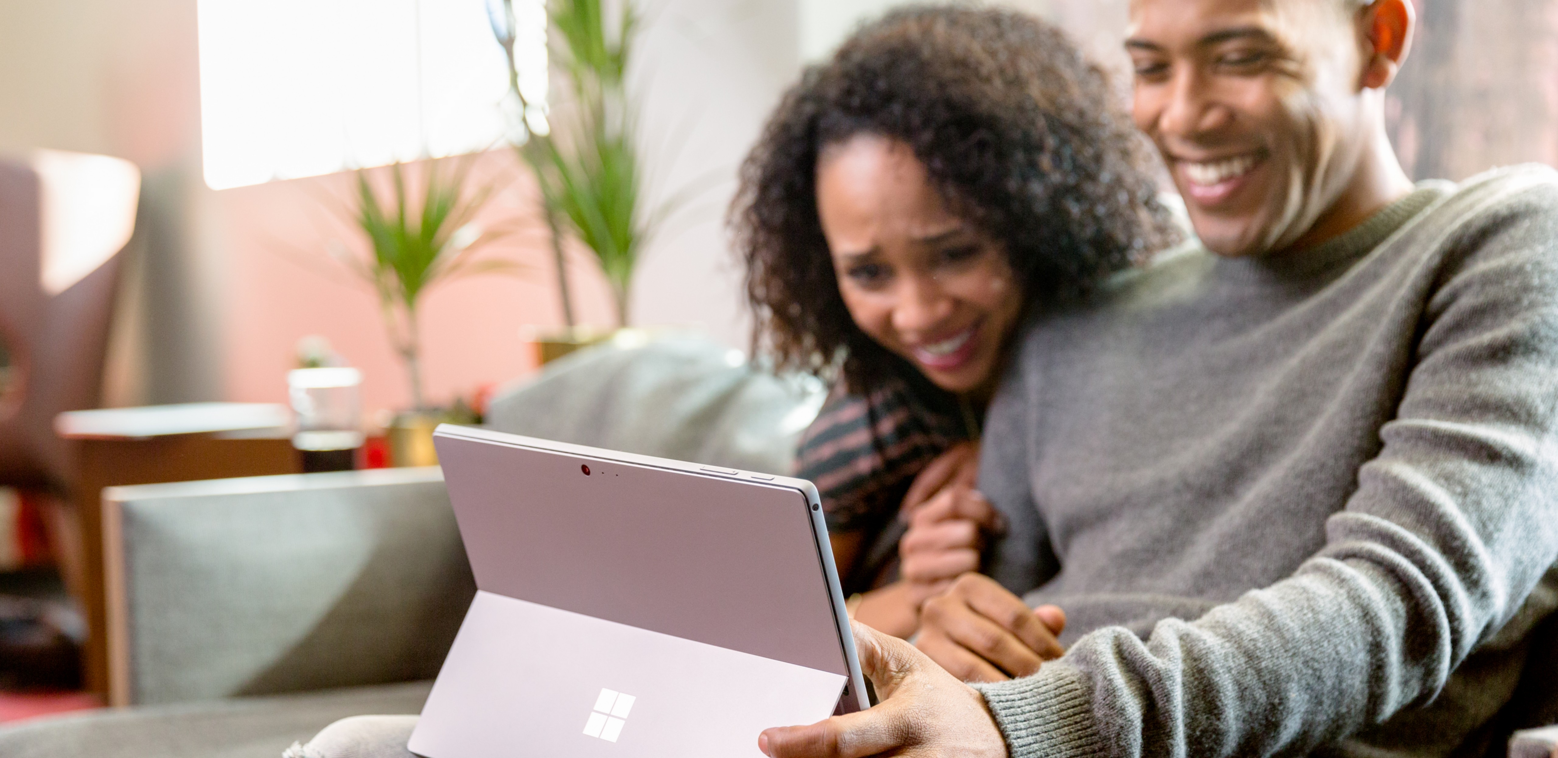 Two people looking at a Surface device