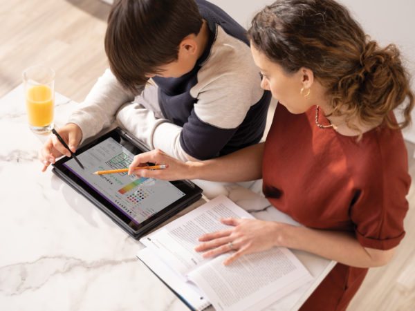 Two students share a tablet device