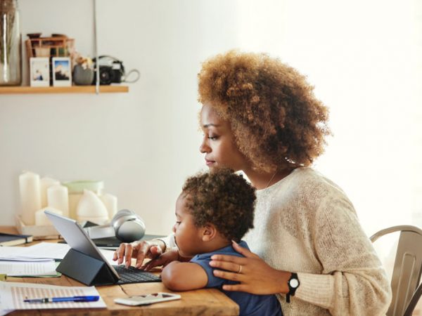 Mother and son look at laptop computer screen together