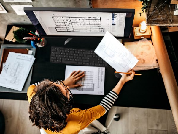 Woman working at a desk in front of Acer Aspire C27 AIO