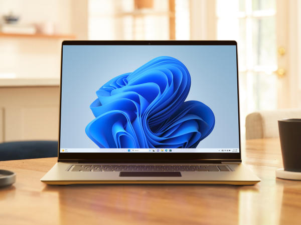 Laptop on kitchen table displaying the Windows 11 Start screen