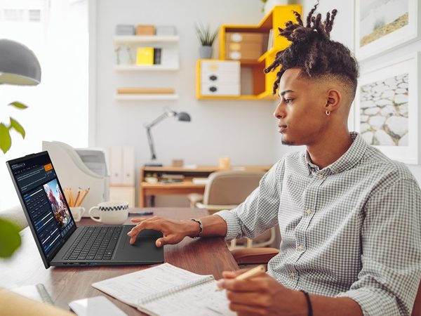 Man sitting at a desk working on a laptop