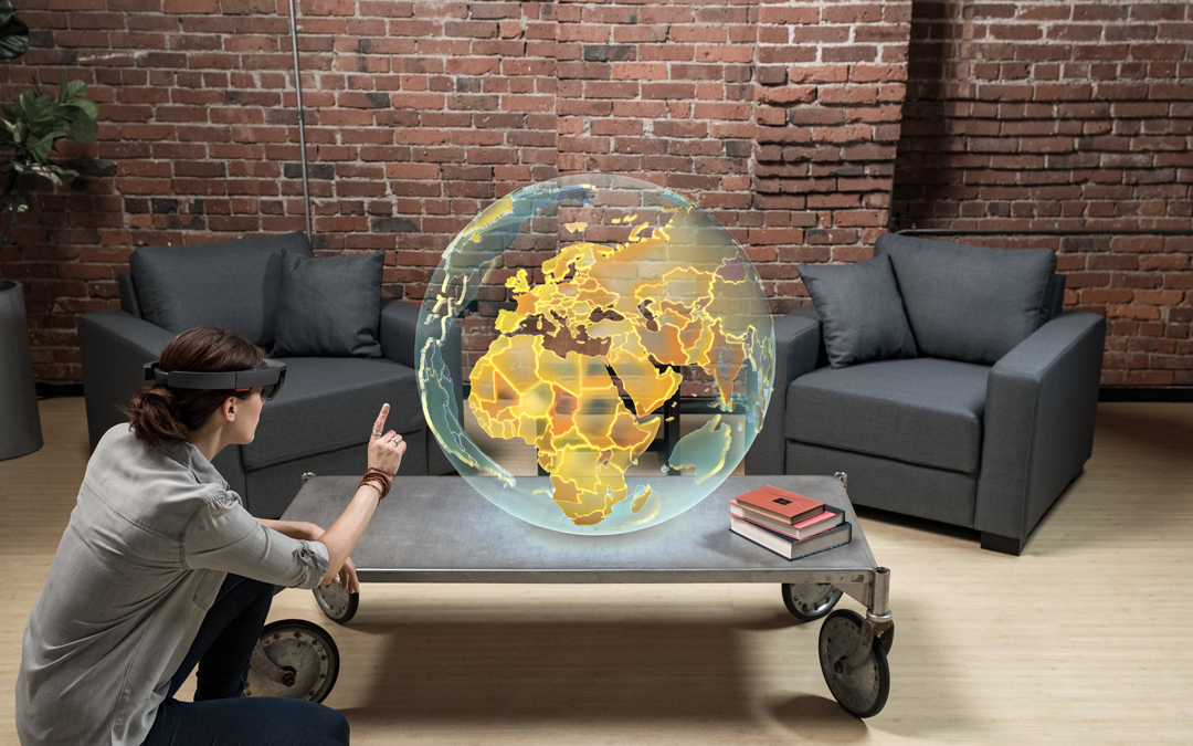 Person wearing HoloLens and pointing at a globe