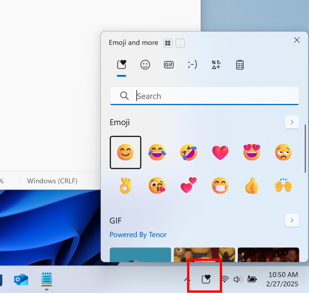 The new system tray icon for the emoji and more panel highlighted with a red box.